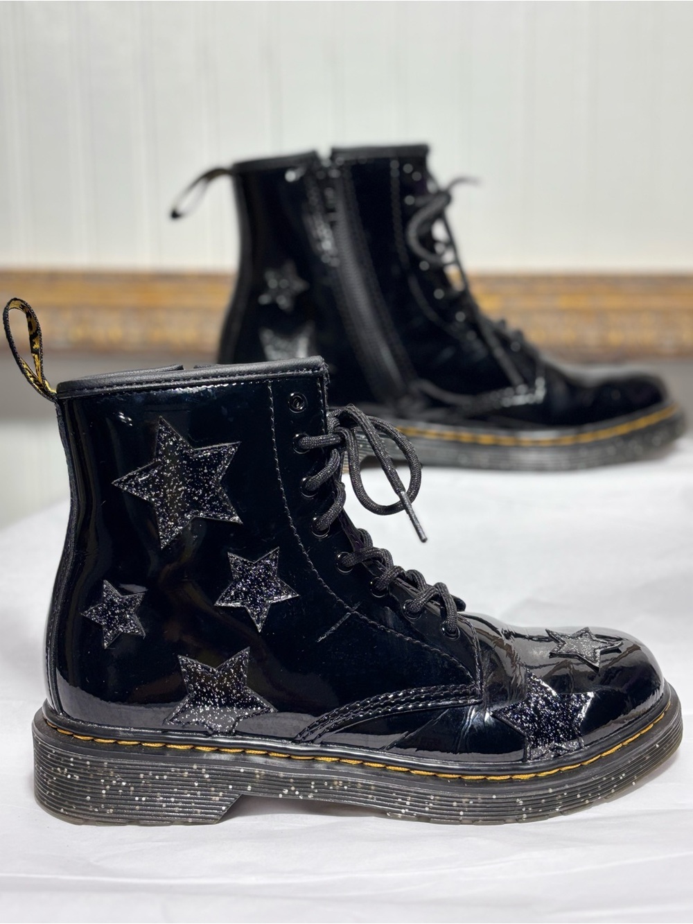 Black patent leather lace up and side zip
star appliqué cool girl boots